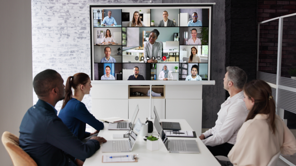 Large video meeting including 20 participants online and 4 in a conference room viewing the screen together